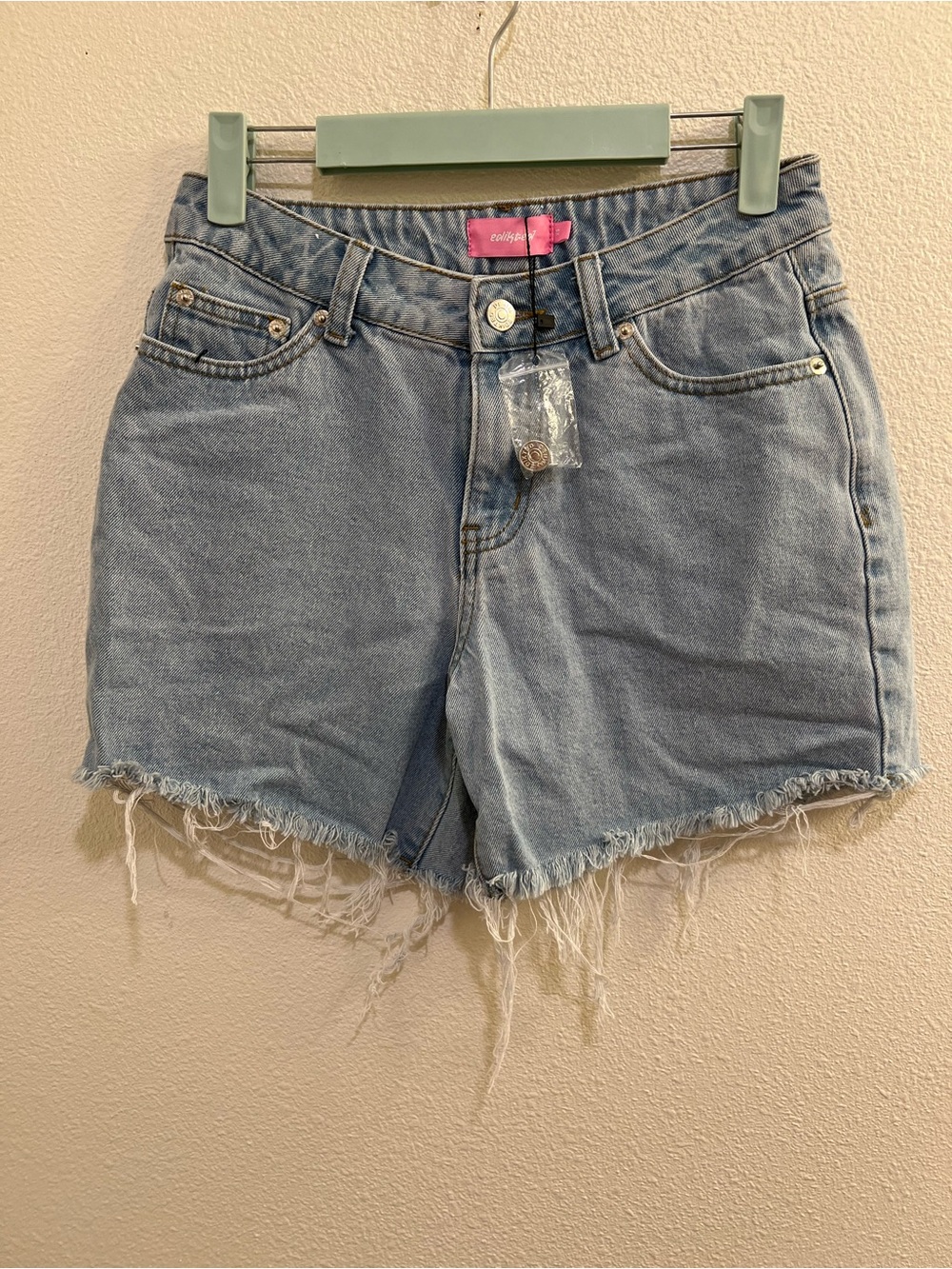 NWOT Edikted light blue denim cutoff shorts featuring a heavily frayed, distress